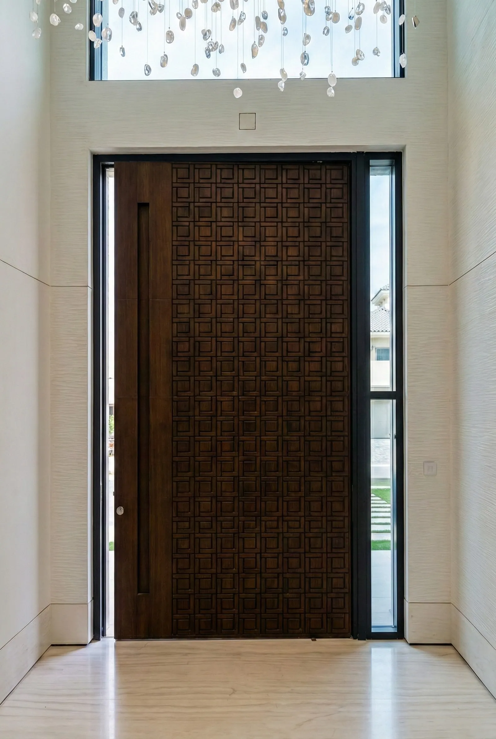 Carved walnut pivot door with geometric relief pattern