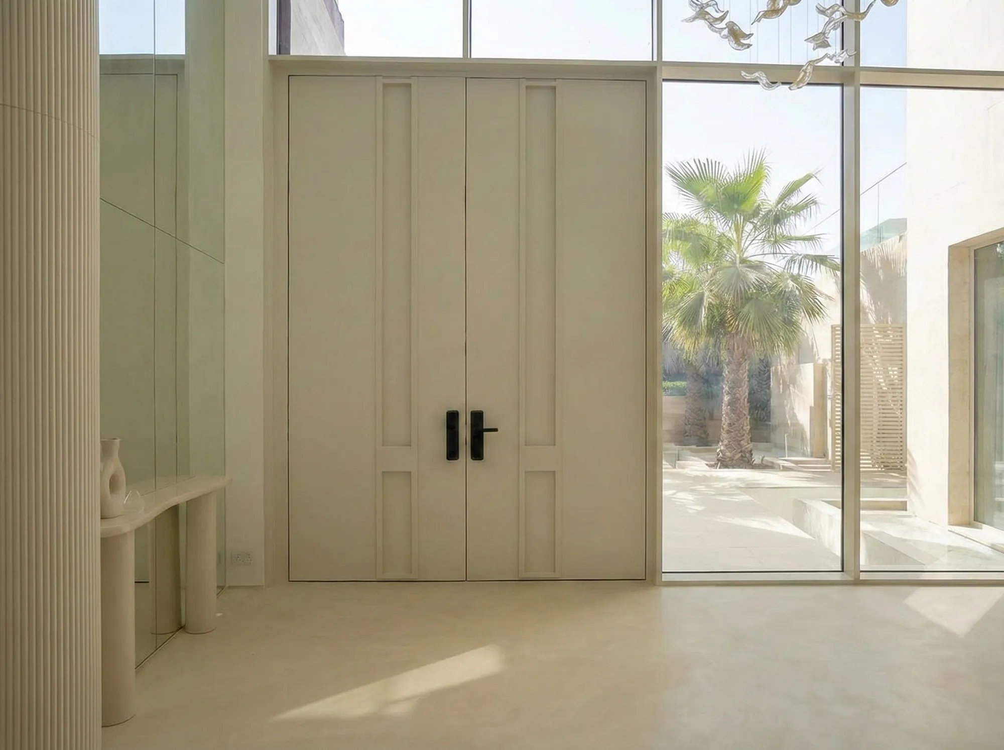 White panelled double doors in a glazed entrance hall