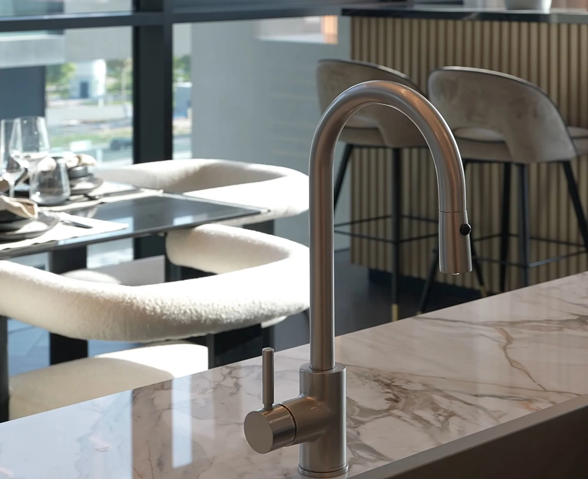 Brushed steel kitchen tap on a marble countertop by Joinery.ae, Dubai