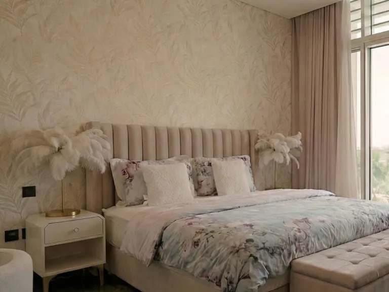 Channel-tufted upholstered headboard in a blush bedroom