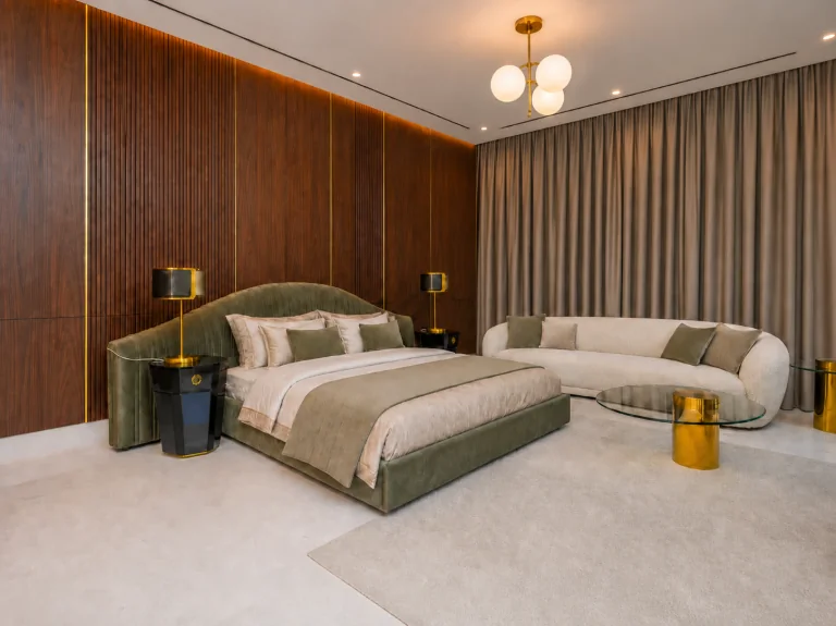 Walnut wall panelling with brass inlay behind an upholstered bed
